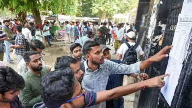 Students checking entry guidelines and CUET UG 2026 revised timings at an examination center.
